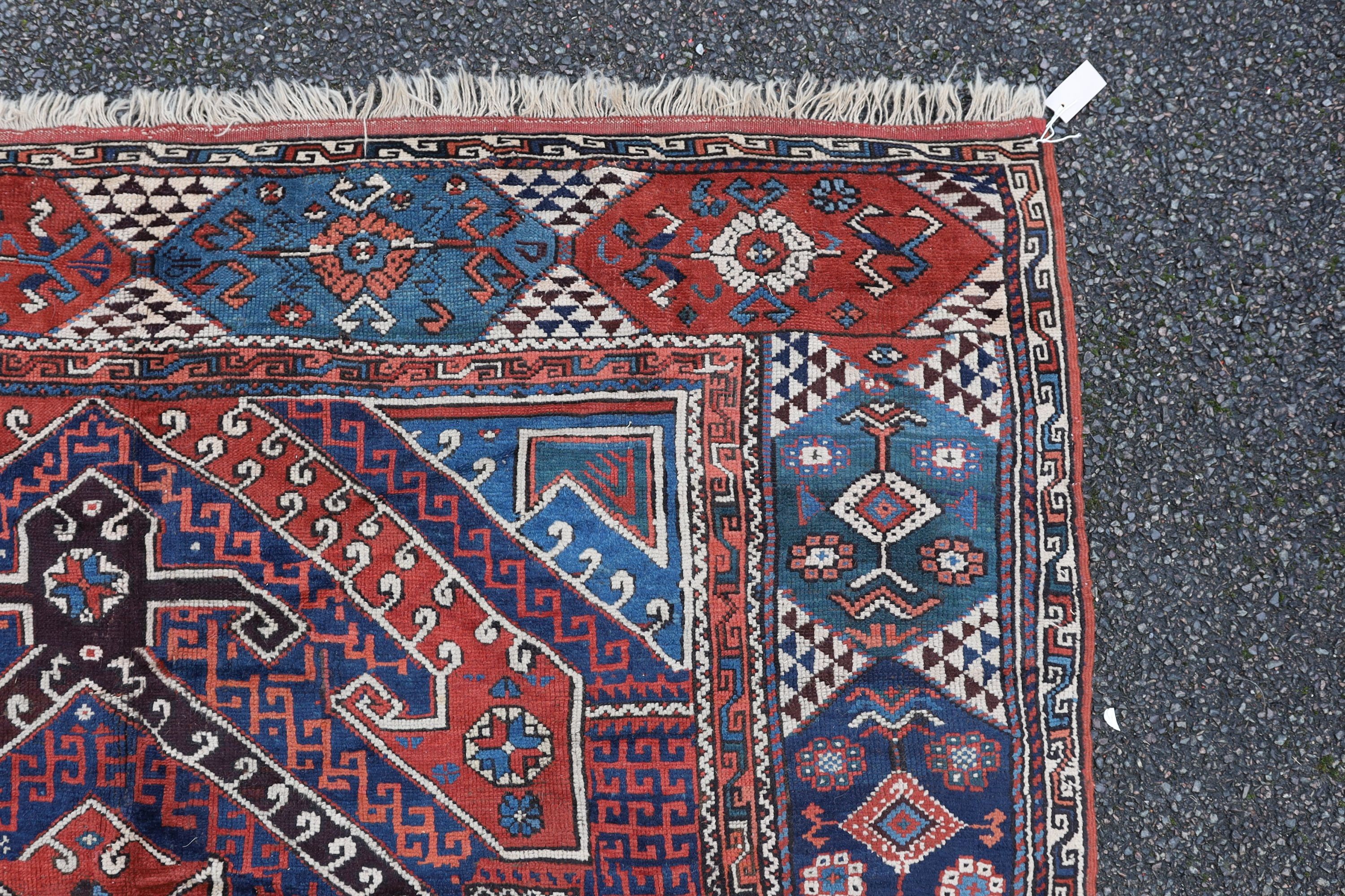 A Bergam Turkish blue ground rug 254 x 198cm